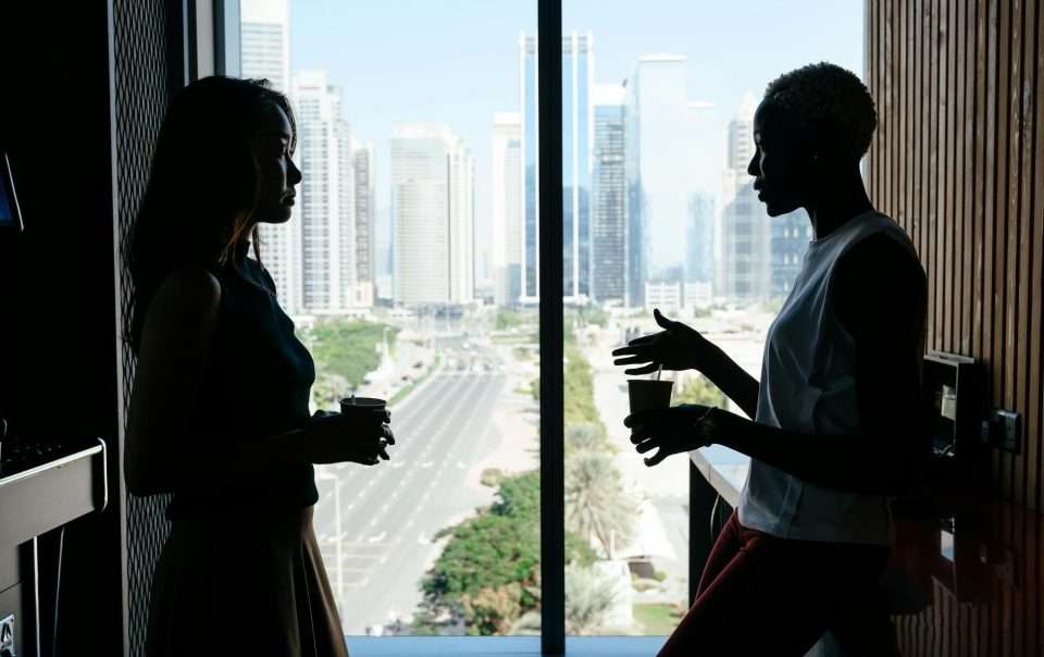 multiethnic women talking about business project in modern office